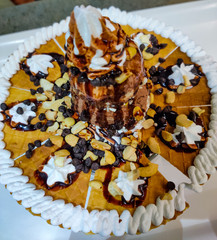 A Cake With Cream And Topping With Chocolate Ice-Cream.