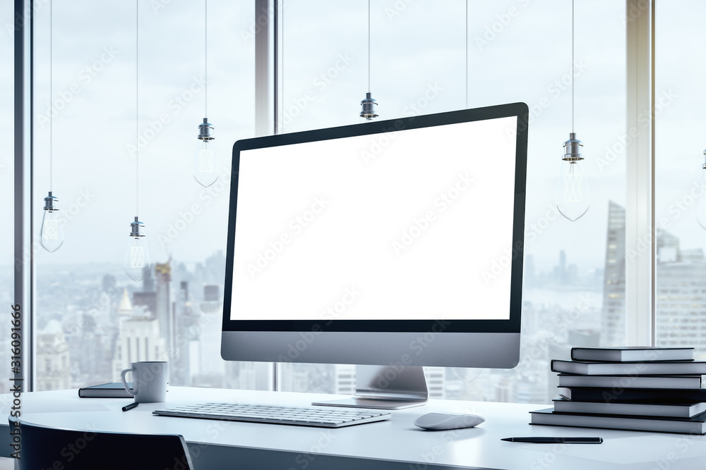 Poster close up of a blank computer screen standing on a white table in modern interior with big window wit