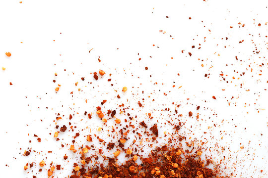 Crushed red cayenne pepper, dried chili flakes isolated on white background, Top view.