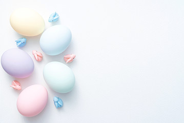 decorative easter eggs on a light wooden background. Easter-themed background with place for text