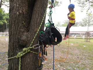 Climber child on training.adventure climbing high wire park - people on course in mountain helmet and safety equipment.