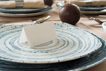 Fototapeta na wymiar Details of a stylish table setting with textured ceramic dishes