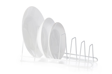 Set of white ceramic dishware on drainer