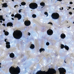 white Christmas tree with black balloons flashing lights and garlands