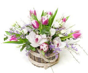Beautiful floral arrangement. Flowers in a box. Tulips, orchid and green leafs                               