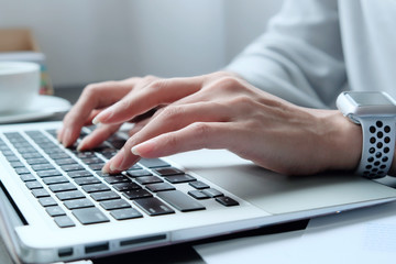Asian woman is typing on keyboard of laptop or computer notebook for check electronic mail, preparation of presentation in meeting, get information for shopping online or operation of internet banking