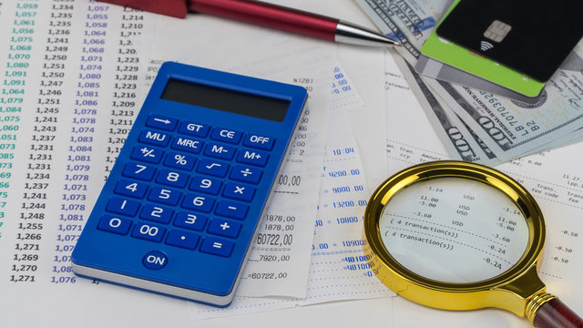 Calculator and us dollars on top of supermarket receipt. Shopping and payment concept