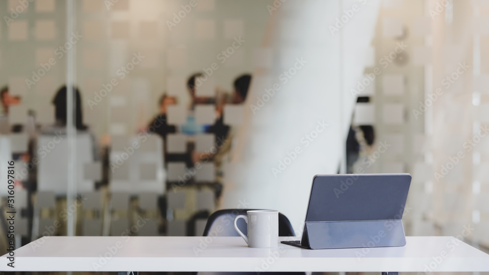 Poster close up view of workspace with digital tablet, coffee cup and copy space on white table with blurre