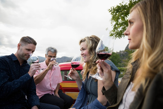 Friends Wine Tasting Red Wine In Truck Bed