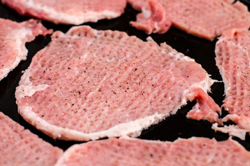 Cooking: chopped pork pieces sprinkled with ground pepper