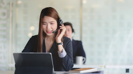 Close up view of female  customer service  talking on headset with smiling