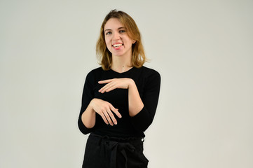 Portrait of a pretty blonde girl in a black t-shirt on a white background with emotions. A universal concept, the picture is suitable for any topic.