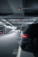 Underground garage or modern car parking with lots of vehicles - obrazy, fototapety, plakaty