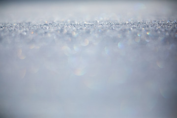 Snow - shallow DOF image of a field covered with fresh snow, splendid play of light can be observed in the snowflakes