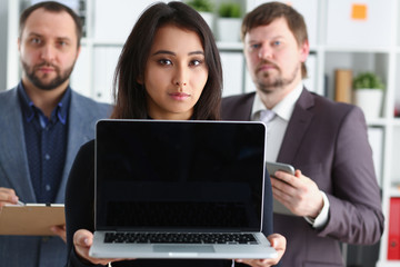 portrait of young successful businesslady hold laptop and two businessmen in office coworkers lovely job concept