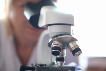Fototapeta na wymiar Woman look microscope on the background laboratory is a study human biology analyzes for non-compliance with the requirements organization public health at international level