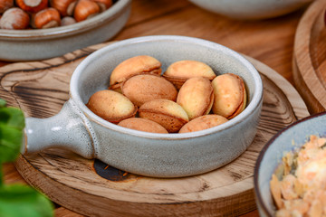 Traditional Georgian dessert. Cookies nuts with condensed milk and nuts served in a bowl on dark wooden table.
