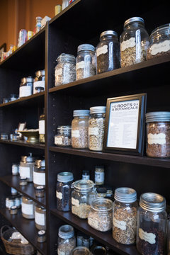 Root And Botanical Spices In Jars On Shelf Display In Shop