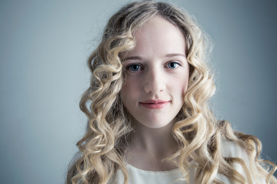 Portrait Confident Caucasian Young Woman With Long Curly Blonde Hair