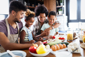 Happy family preparing together food in the kitchen