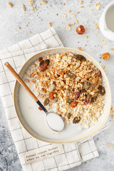 Organic homemade granola cereal with oats, nuts and dried berries. Muesli in a glass jar. Healthy vegan breakfast or snack. Copy space for text. Proper nutrition concept