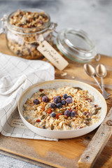 Organic homemade granola cereal with oats, nuts and dried berries. Muesli in a glass jar. Healthy vegan breakfast or snack. Proper nutrition concept