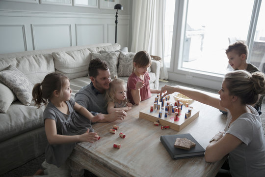 Young family playing game in living room