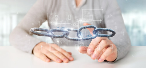 Fototapeta premium Businessman holding a virtual Blockcahin with data - 3d rendering
