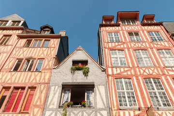 Row of old multicolored timber-framed houses in historic city center of Rouen, France