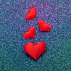 Red hearts symbol of love on a shiny blue background. Valentines day concept. Horizontal frame copy space.