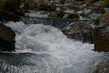 White water froths as it rushes down a river bed