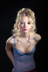 attractive female model in lingerie posing on dark studio background 