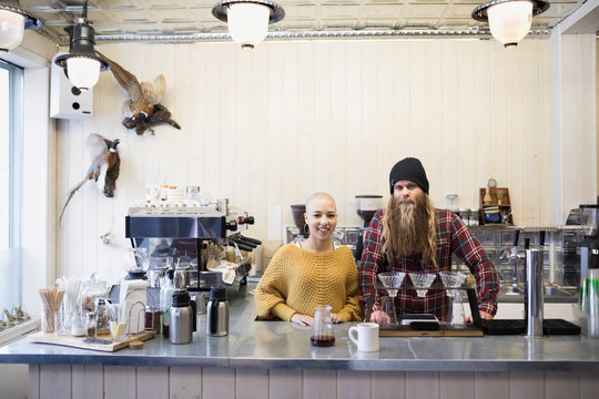 Portrait confident baristas working in cafe