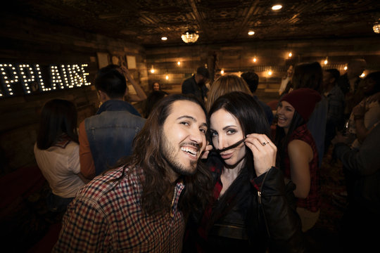 Portrait Playful Couple At Music Concert