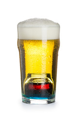 Deep-bomb cocktail of beer, liquor and vodka, with a thick cap of foam in a steamed glass, prepared by mixing a submerged inverted Cup at the bottom of a beer glass. Isolated on white.
