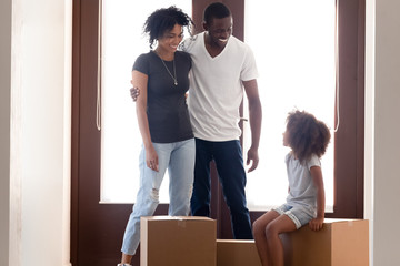 Excited black family moving to new home with daughter