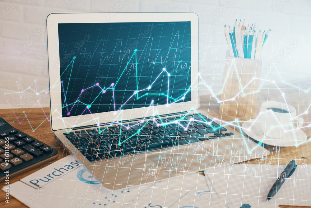 Wall mural double exposure of graph and financial info and work space with computer background. concept of inte