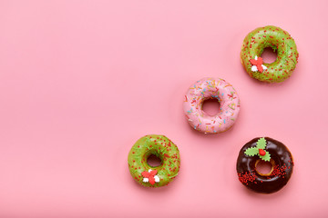 Sweet donuts of different colors, on a pink background. Copy space, blue and pink backgrounds