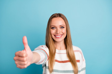Photo of cheerful positive cute nice pretty woman showing you thumb up liked your work done well...