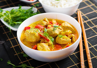 Indian chicken curry with basmati rice in bowl.  Traditional Indian dish. Chicken tikka masala. Indian cuisine.