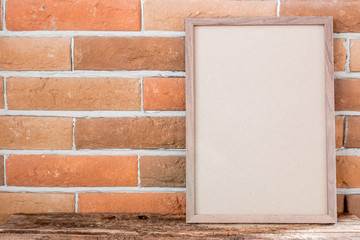 Fototapeta premium empty photo frame on brick background with place for text