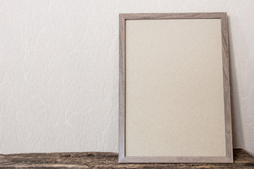 Fototapeta premium empty photo frame on wooden background with place for text