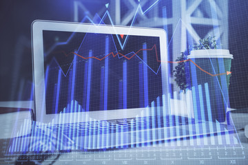 Financial graph colorful drawing and table with computer on background. Multi exposure. Concept of international markets.