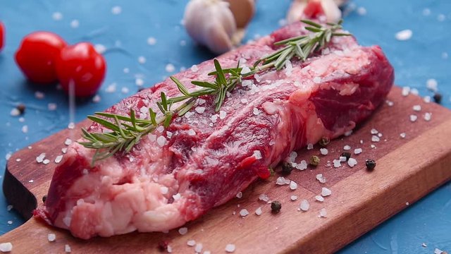 Raw fresh meat Steak with herbs and spices on rustic background