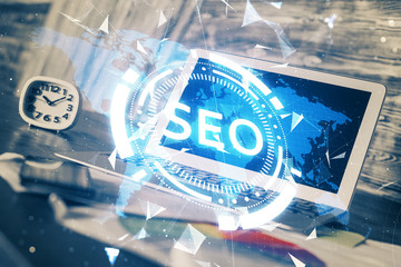 Multi exposure of table with computer and seo drawing hologram. Search optimization concept.
