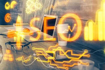 Multi exposure of table with computer and seo drawing hologram. Search optimization concept.