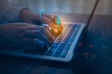 Businessman using a laptop computer with technology cybersecurity and privacy concept. protection and safe data for global network security.