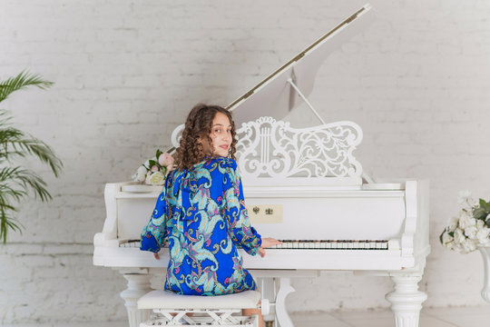 Teeager girl at the piano, classical music concept