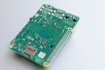 A Raspberry Pi 4 board, isolated on silver background. The Raspberry Pi is a series of single-board computers developed by the Raspberry Pi Foundation.