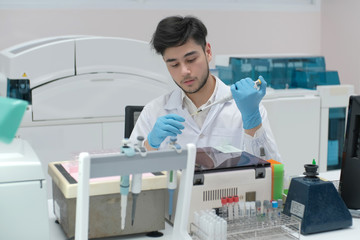 Man in white uniform in laboratory work on analize.